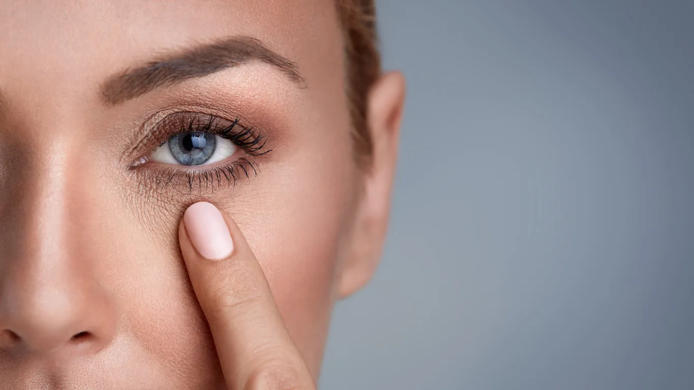 woman checking wrinkles around the eyes, close up woman checking wrinkles around the eyes, close up