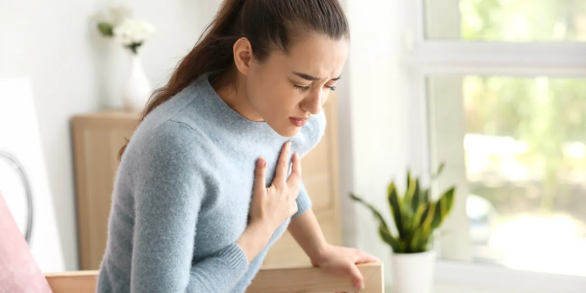 young woman suffering from heart attack at home young woman suffering from heart attack at home