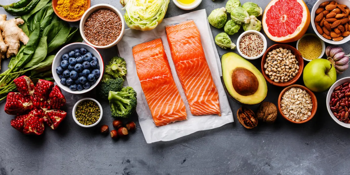 healthy food clean eating selection fish, fruit, vegetable, seeds, superfood, cereals, leaf vegetable on gray concrete background copy space healthy food clean eating selection fish, fruit, vegetable, seeds, superfood, cereals, leaf vegetable on gray concrete background copy space