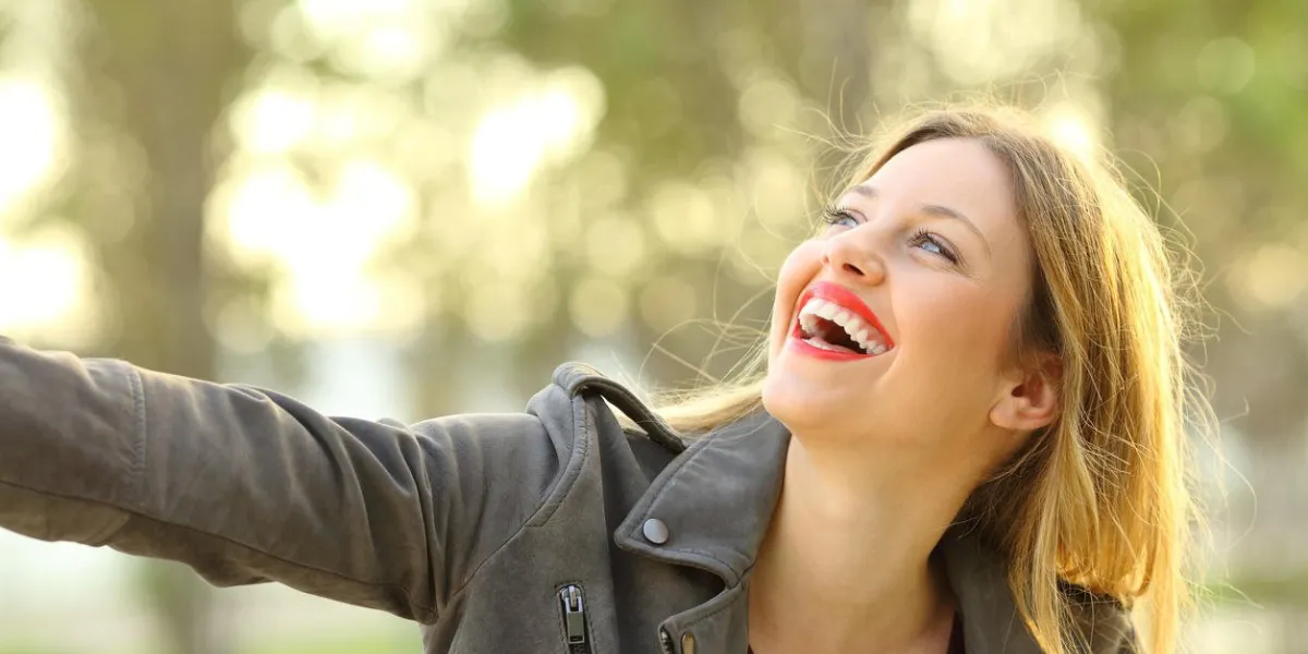 portrait of a candid girl laughing and joking outdoors in a park portrait of a candid girl laughing and joking outdoors in a park