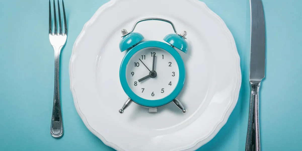 intermittent fastin concept - empty plate on blue background, copy space intermittent fastin concept - empty plate on blue background, copy space