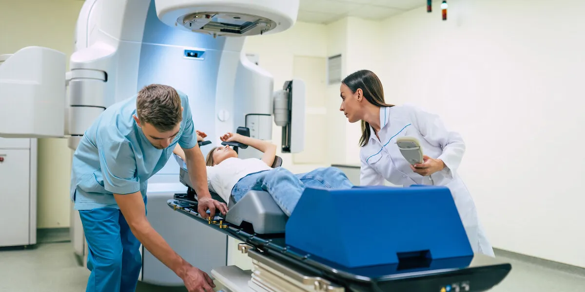 cancer treatment in a modern medical private clinic or hospital with a linear accelerator professional doctors team working while the woman is undergoing radiation therapy for cancer cancer treatment in a modern medical private clinic or hospital with a linear accelerator professional doctors team working while the woman is undergoing radiation therapy for cancer