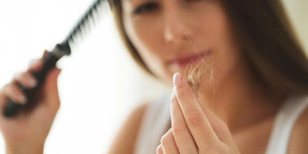woman suffers from hair loss woman suffers from hair loss