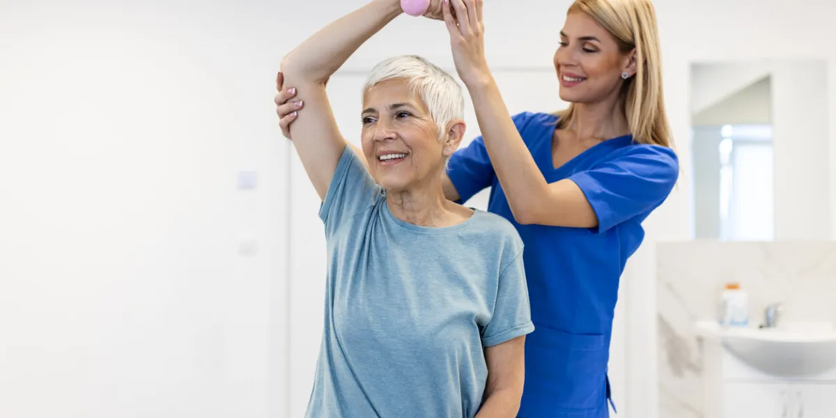 physiotherapist woman giving exercise with dumbbell treatment about arm and shoulder of senior female patient physical therapy concept physiotherapist woman giving exercise with dumbbell treatment about arm and shoulder of senior female patient physical therapy concept