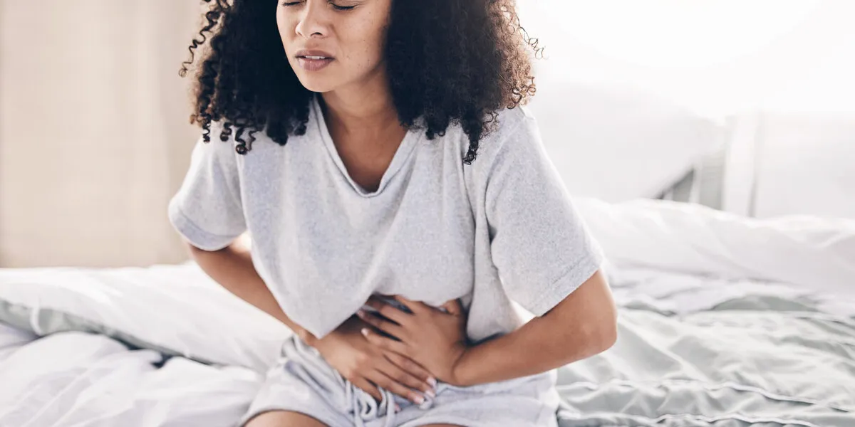 abdomen pain, period and black woman in bed with abdominal cramps, menstruation and stomach ache health, medical emergency and girl with digestion problem, pms crisis and endometriosis in bedroom abdomen pain, period and black woman in bed with abdominal cramps, menstruation and stomach ache health, medical emergency and girl with digestion problem, pms crisis and endometriosis in bedroom
