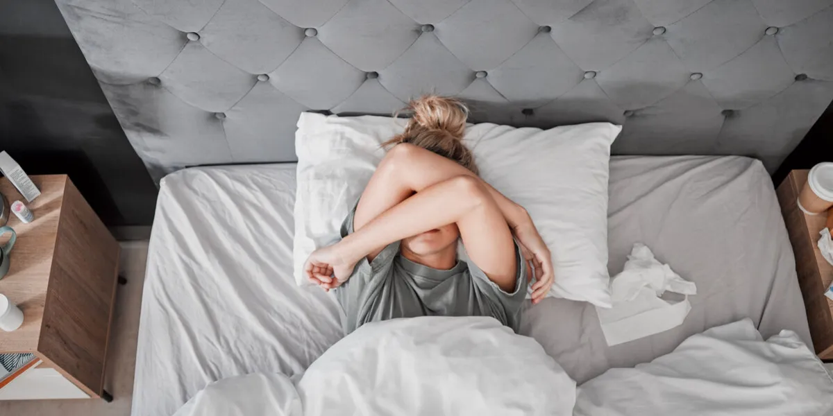 tired, sad and sick woman in bed with insomnia in the bedroom of house from above top view of girl with depression, anxiety and mental health problem thinking of sleep, stress and burnout in home tired, sad and sick woman in bed with insomnia in the bedroom of house from above top view of girl with depression, anxiety and mental health problem thinking of sleep, stress and burnout in home